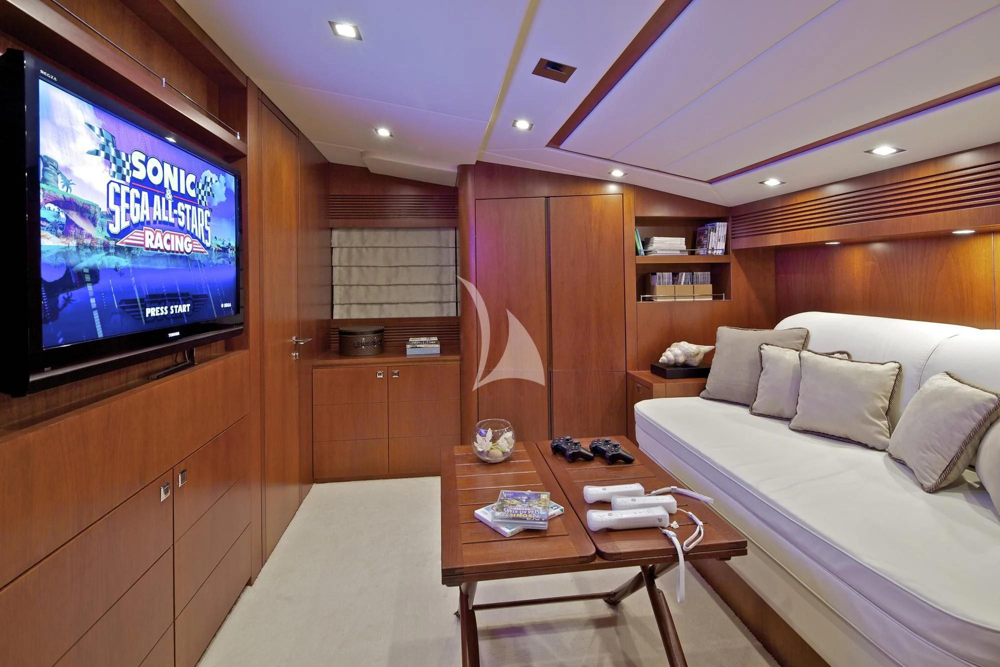 a living room with a tv and a bed aboard BIANCA Yacht for Sale