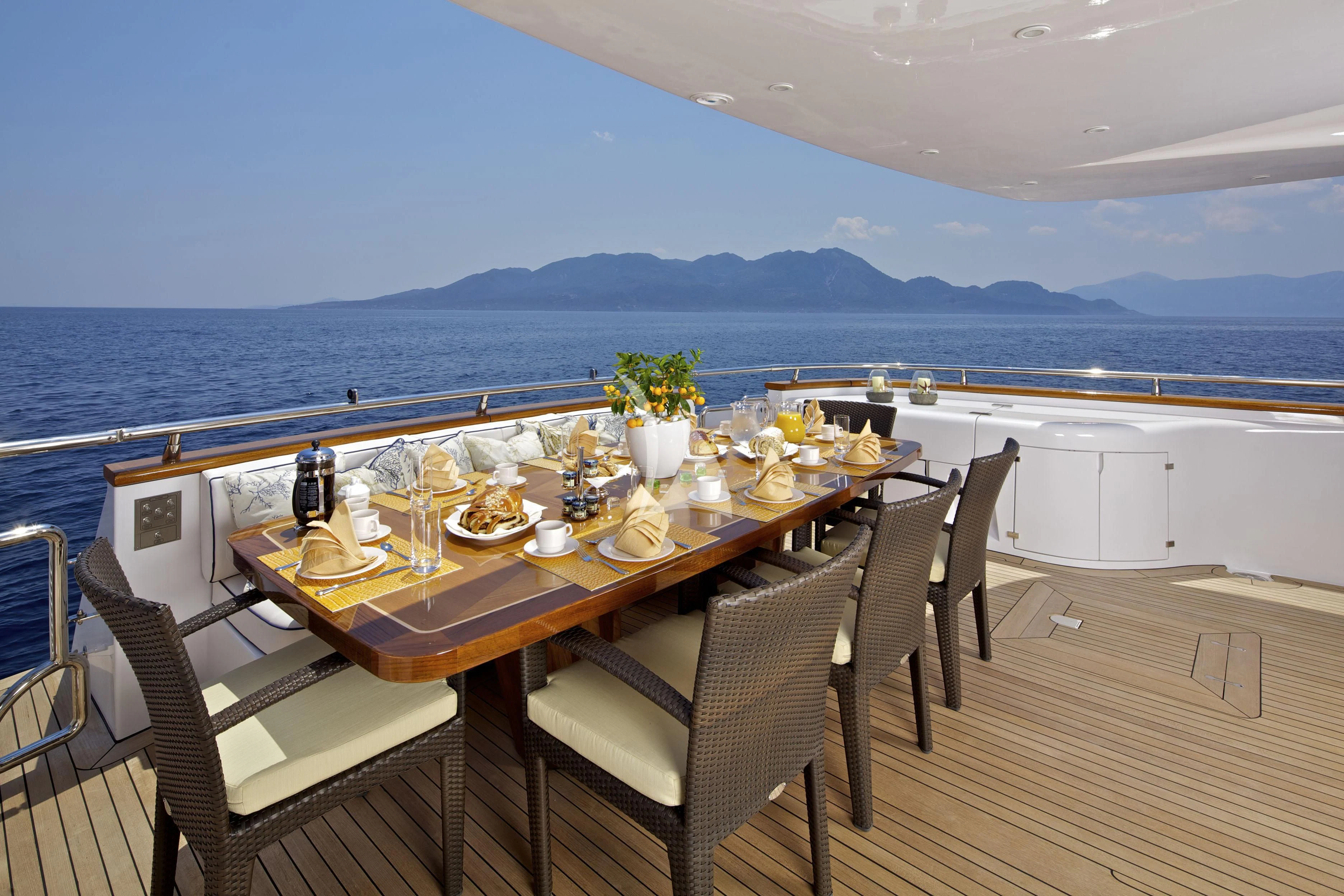 a table on a deck overlooking the ocean aboard BIANCA Yacht for Sale