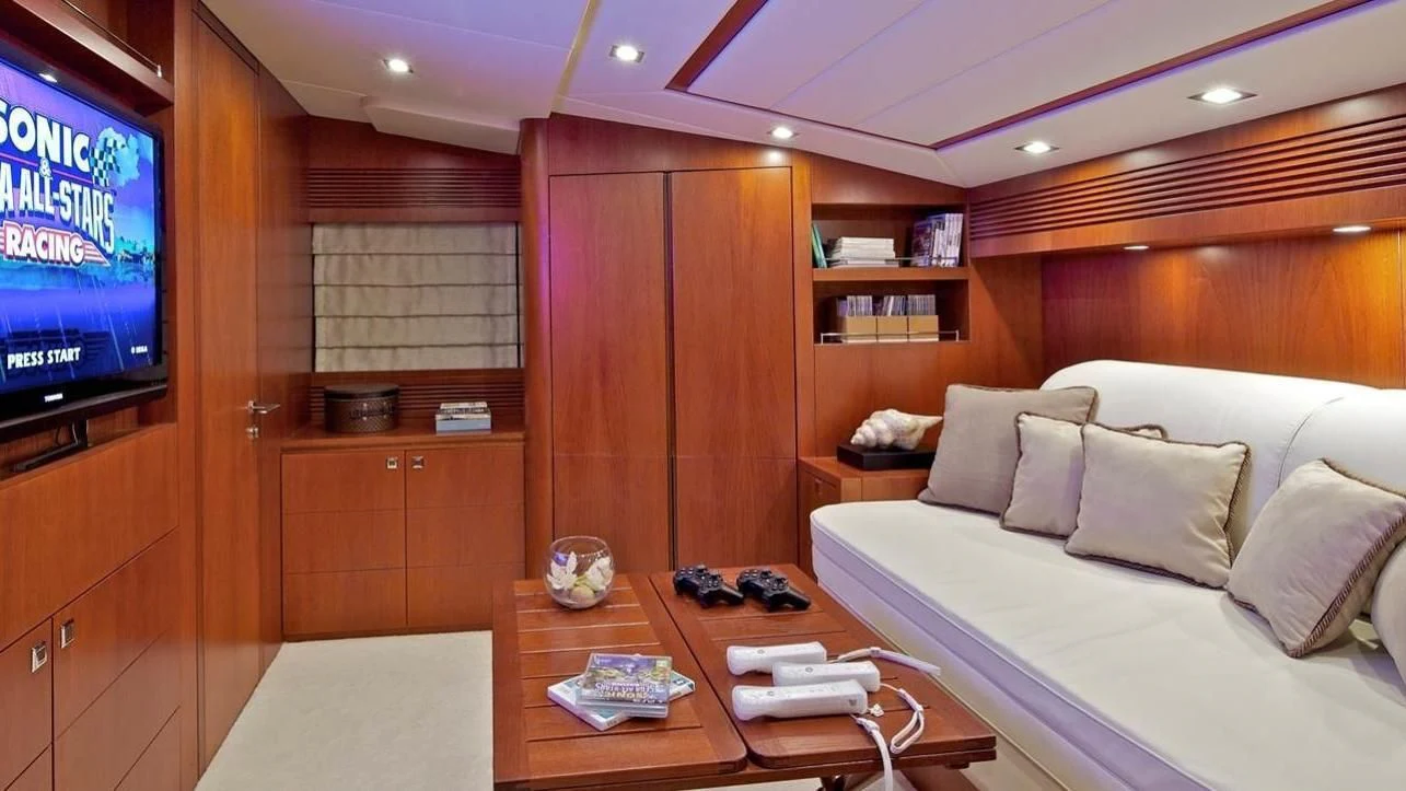 a room with a bed and a television aboard BIANCA Yacht for Sale