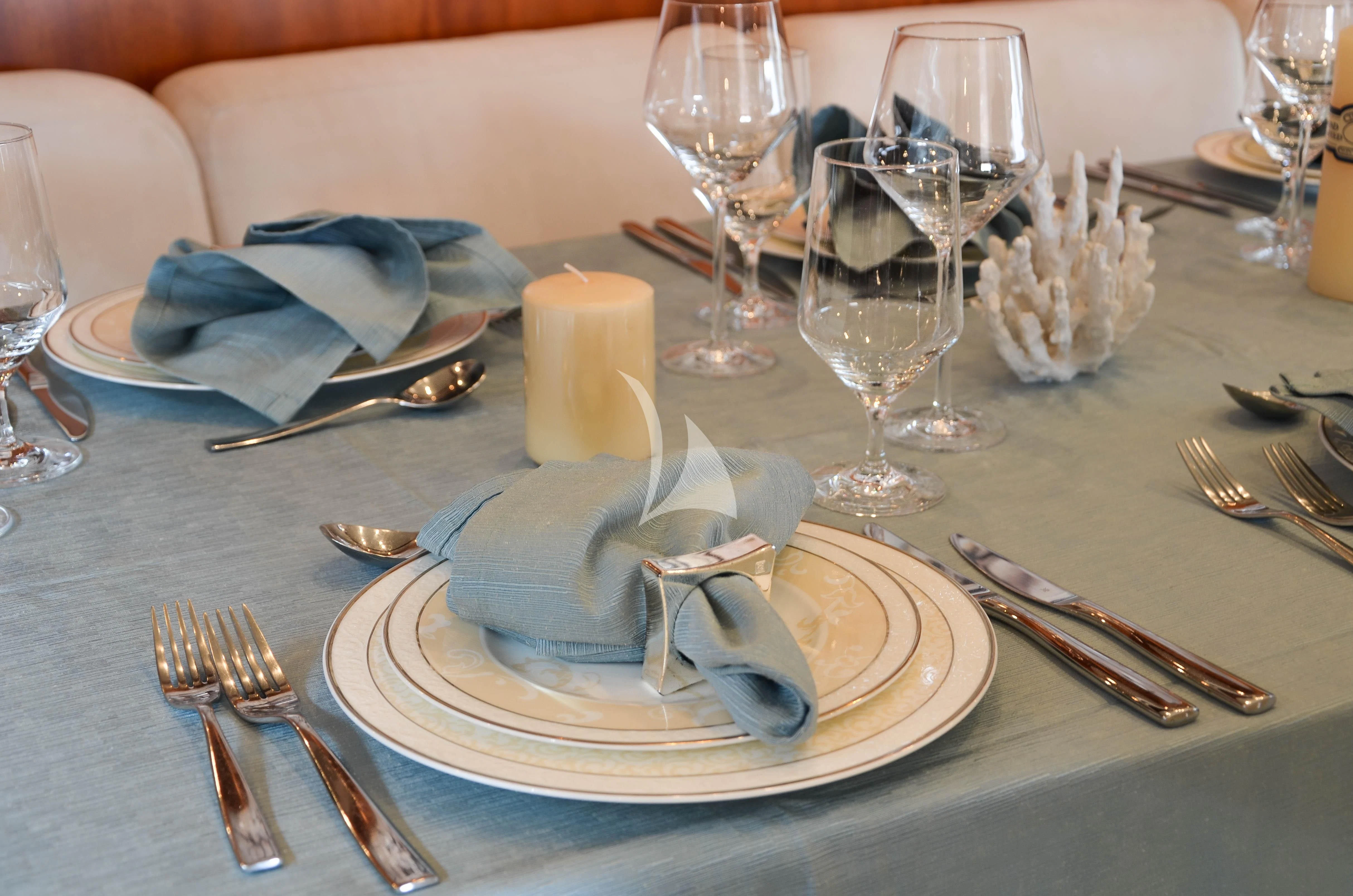 a plate with silverware and silverware on it aboard BIANCA Yacht for Sale