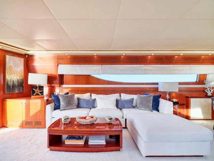 a living room with a white couch aboard BIANCA Yacht for Sale