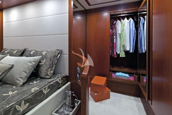 a bedroom with a closet and bed aboard BIANCA Yacht for Sale