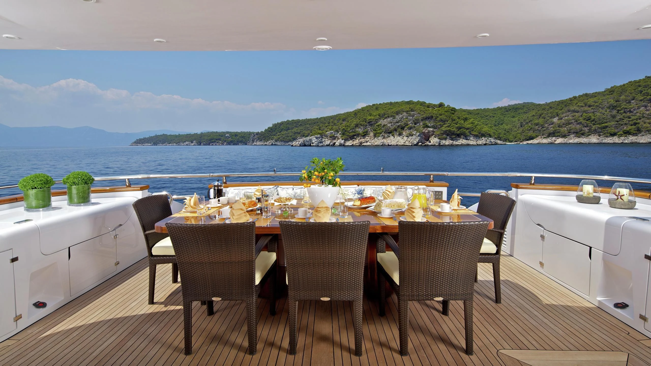 a table set for a meal on a balcony overlooking the ocean aboard BIANCA Yacht for Sale
