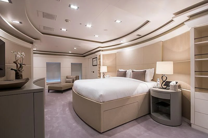 a bedroom with a bed and a desk aboard TRIPLE SEVEN Yacht for Sale