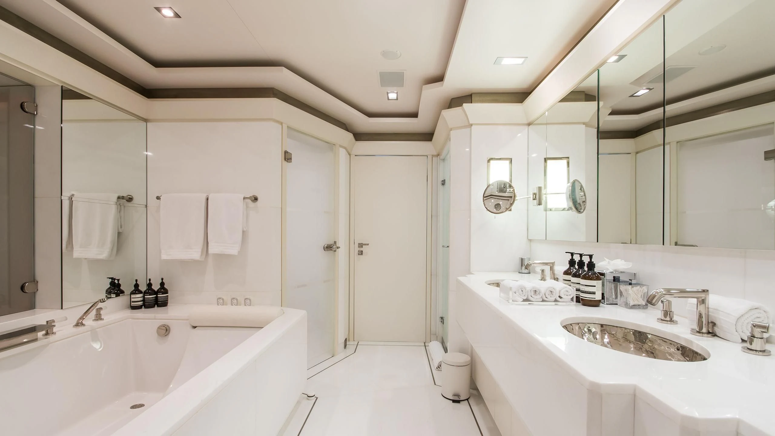 a bathroom with a tub sink and a shower unit aboard TRIPLE SEVEN Yacht for Sale