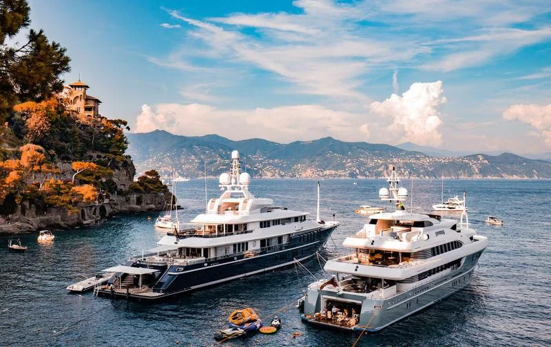 a couple of boats are parked in the water aboard TRIPLE SEVEN Yacht for Sale