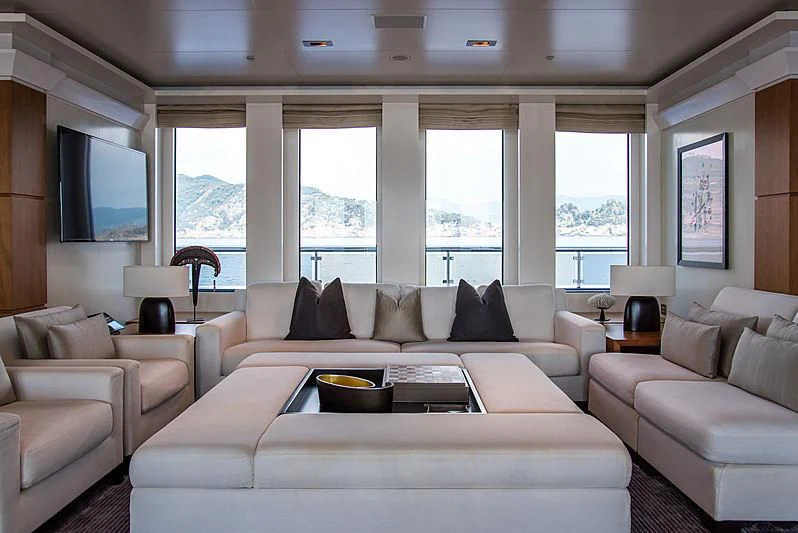 a living room with a large window aboard TRIPLE SEVEN Yacht for Sale