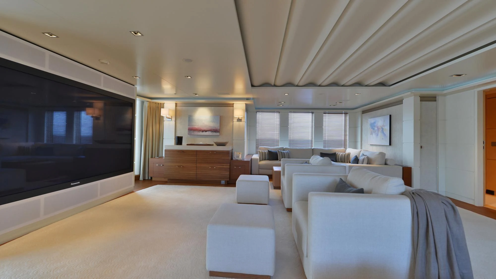 a large living room with a large tv aboard TRIPLE SEVEN Yacht for Sale