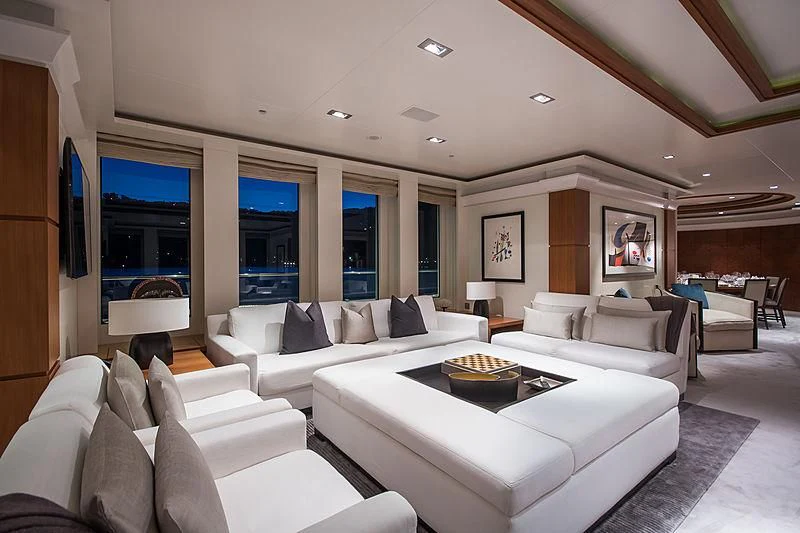 a living room with white couches aboard TRIPLE SEVEN Yacht for Sale