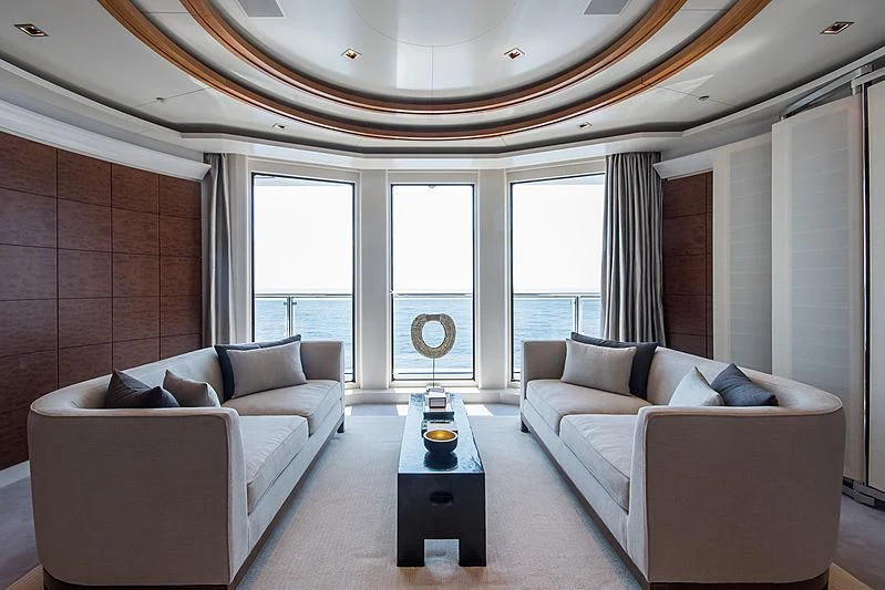 a living room with a couch and a table aboard TRIPLE SEVEN Yacht for Sale