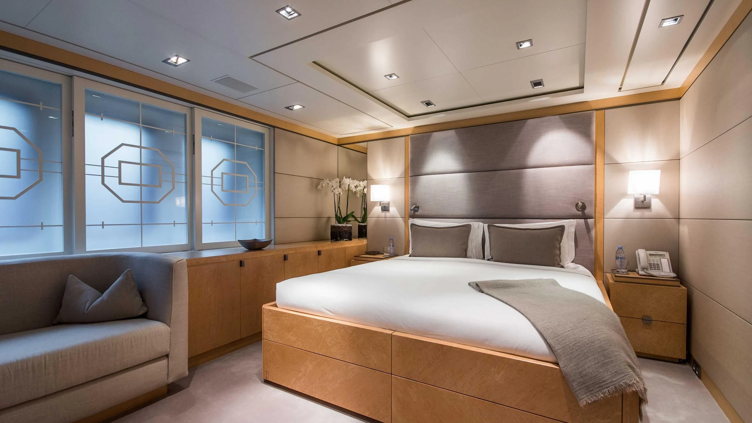 a room with a bed and a couch aboard TRIPLE SEVEN Yacht for Sale