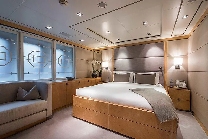 a bedroom with a bed and a couch aboard TRIPLE SEVEN Yacht for Sale