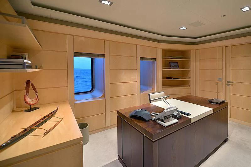 a room with a desk and a window aboard TRIPLE SEVEN Yacht for Sale