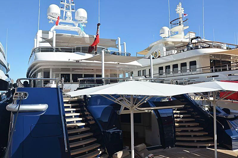 a large white boat with a staircase aboard TRIPLE SEVEN Yacht for Sale