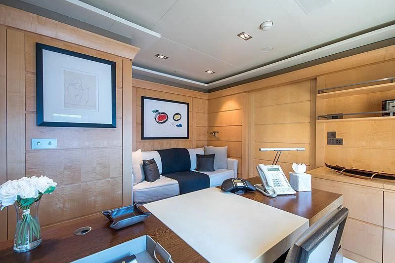 a room with a couch and a table aboard TRIPLE SEVEN Yacht for Sale