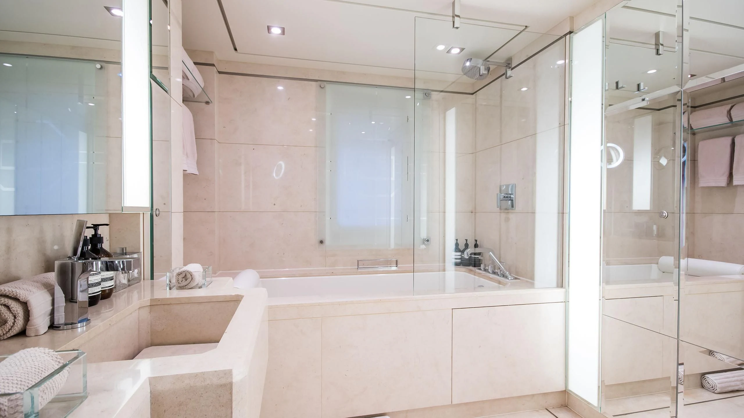 a bathroom with a bathtub and sink aboard TRIPLE SEVEN Yacht for Sale