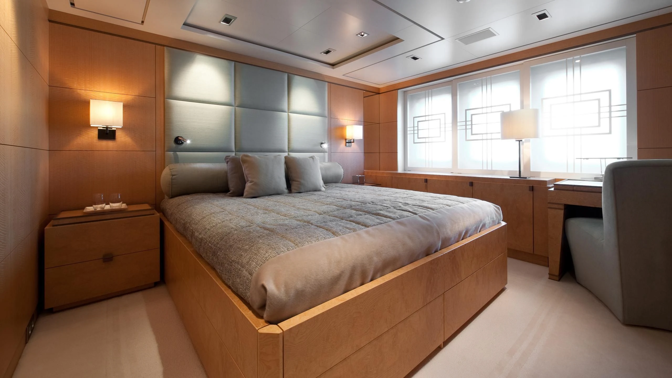 a bedroom with a bed and a chair aboard TRIPLE SEVEN Yacht for Sale