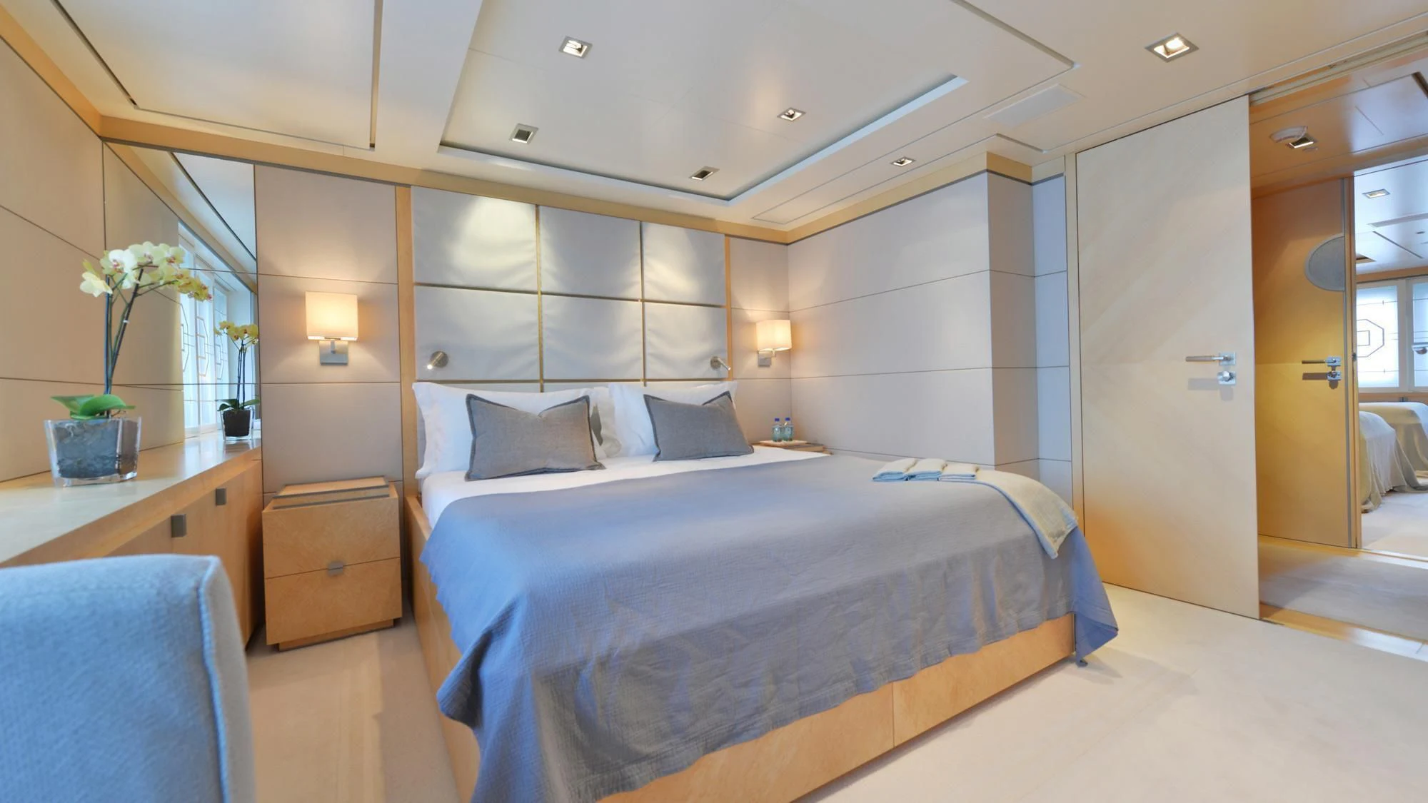 a bedroom with a bed and a desk aboard TRIPLE SEVEN Yacht for Sale