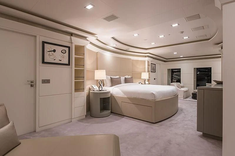 a large white room with a bed and a tv aboard TRIPLE SEVEN Yacht for Sale