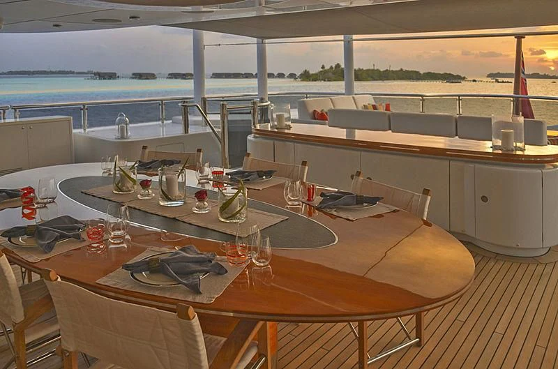 a table with glasses and bottles on it aboard TRIPLE SEVEN Yacht for Sale