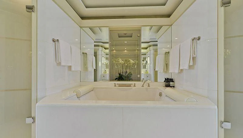 a bathroom with a large mirror aboard TRIPLE SEVEN Yacht for Sale