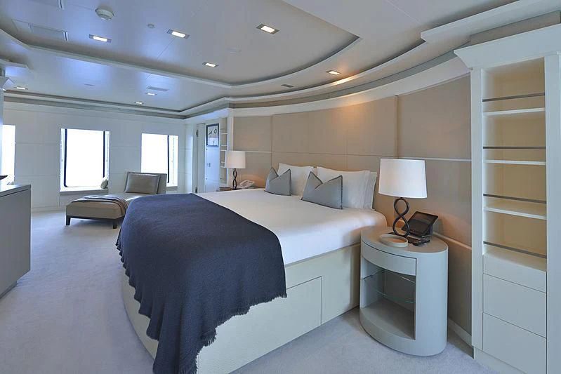 a bedroom with a bed and a desk aboard TRIPLE SEVEN Yacht for Sale
