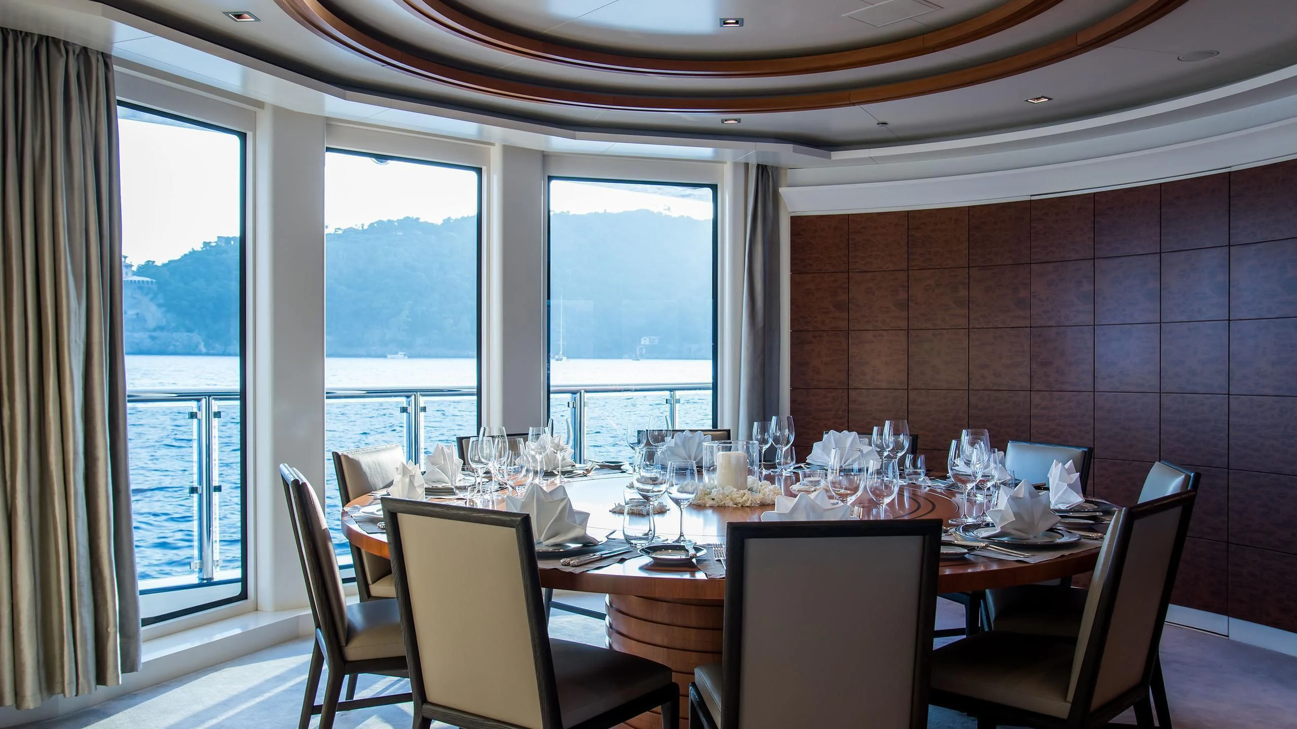 a dining room with a large window aboard TRIPLE SEVEN Yacht for Sale
