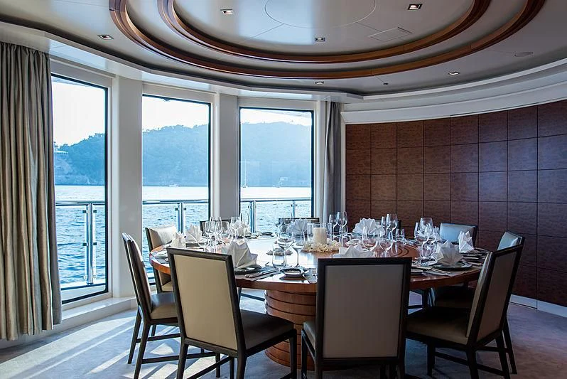 a dining table with a view of the ocean aboard TRIPLE SEVEN Yacht for Sale
