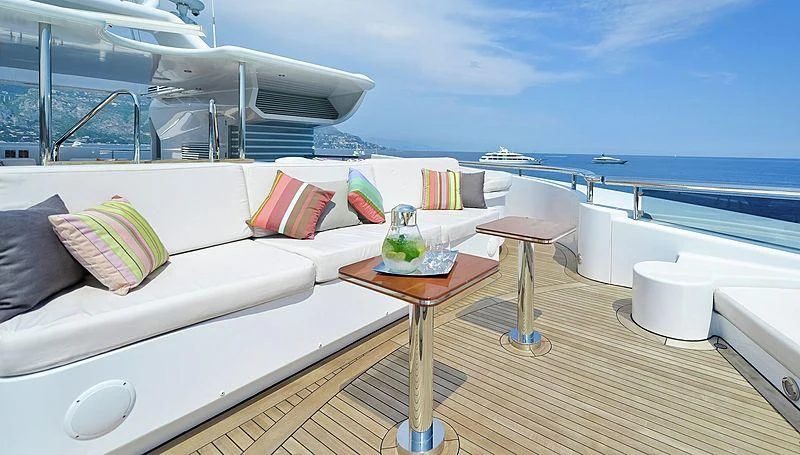 a room with a bed and a table and a window aboard TRIPLE SEVEN Yacht for Sale