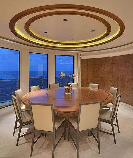 a dining table with chairs around it aboard TRIPLE SEVEN Yacht for Sale