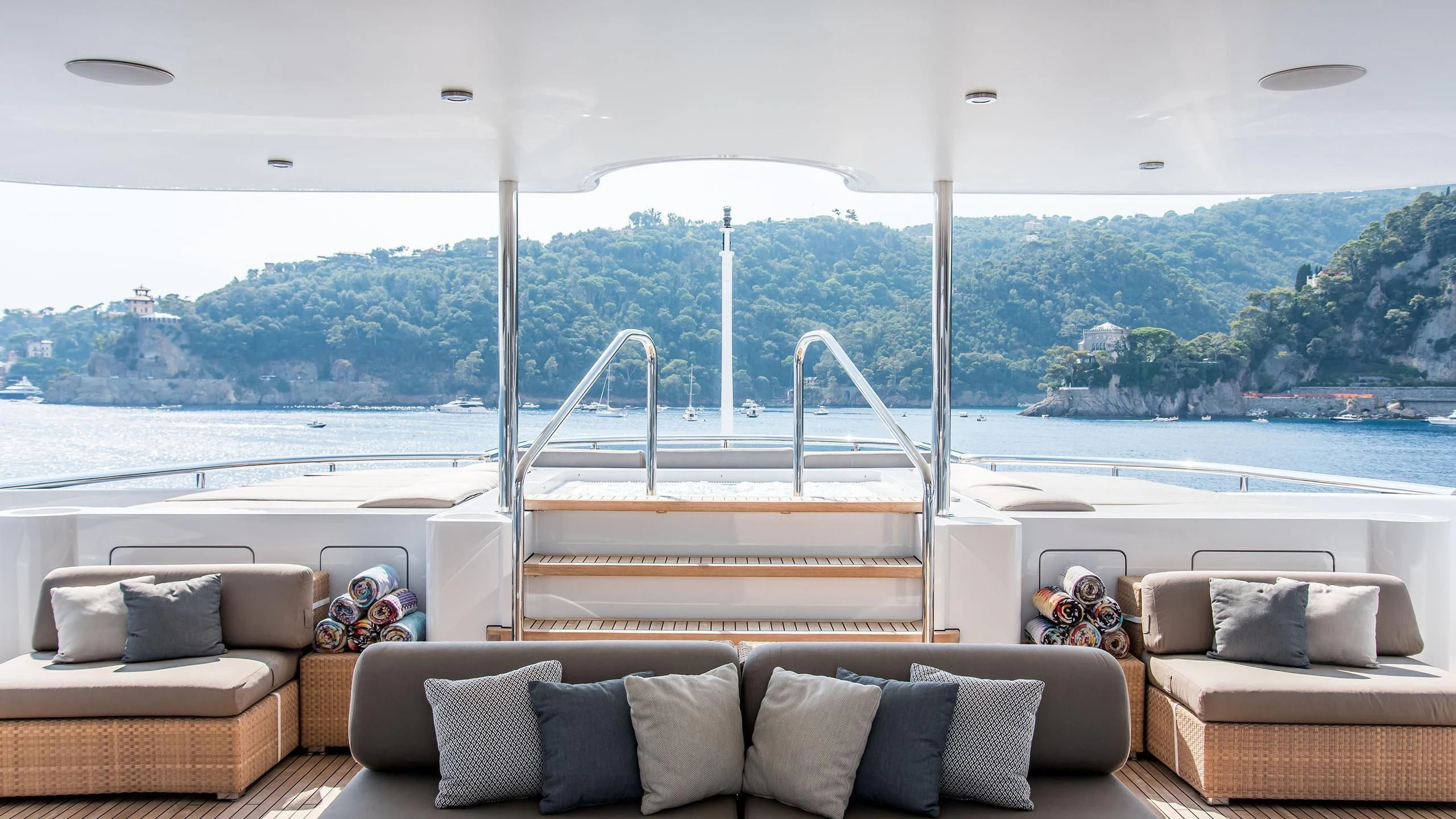 a living room with a view of the water and a city aboard TRIPLE SEVEN Yacht for Sale