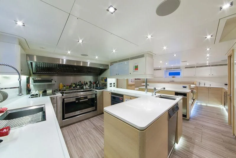 a kitchen with a large island aboard ANATTA Yacht for Sale