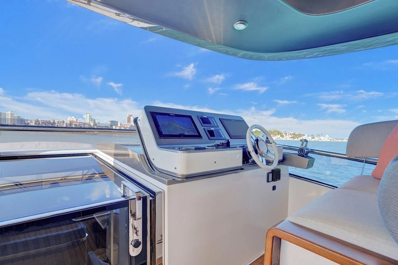 a boat with a view of a city and water below aboard ENCHANTE Yacht for Sale