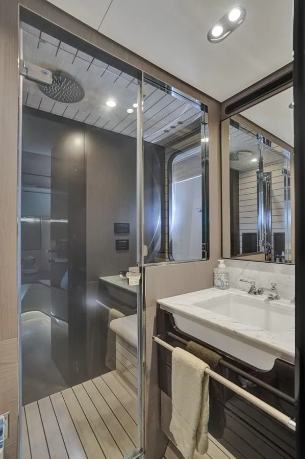 a bathroom with a large mirror aboard ENCHANTE Yacht for Sale