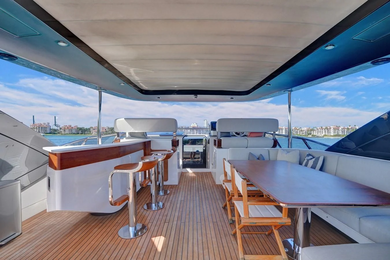 a boat deck with tables and chairs aboard ENCHANTE Yacht for Sale