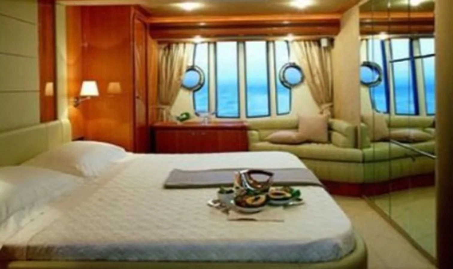 a bed with a white sheet aboard DELMARE Yacht for Sale