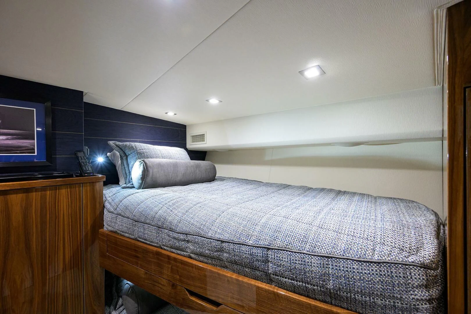 a bed with a blue comforter aboard FORTY NINER Yacht for Sale