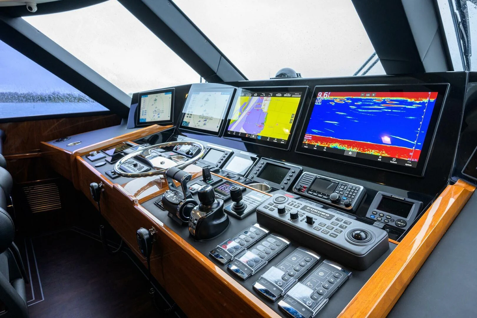 a desk with a computer and several monitors aboard FORTY NINER Yacht for Sale