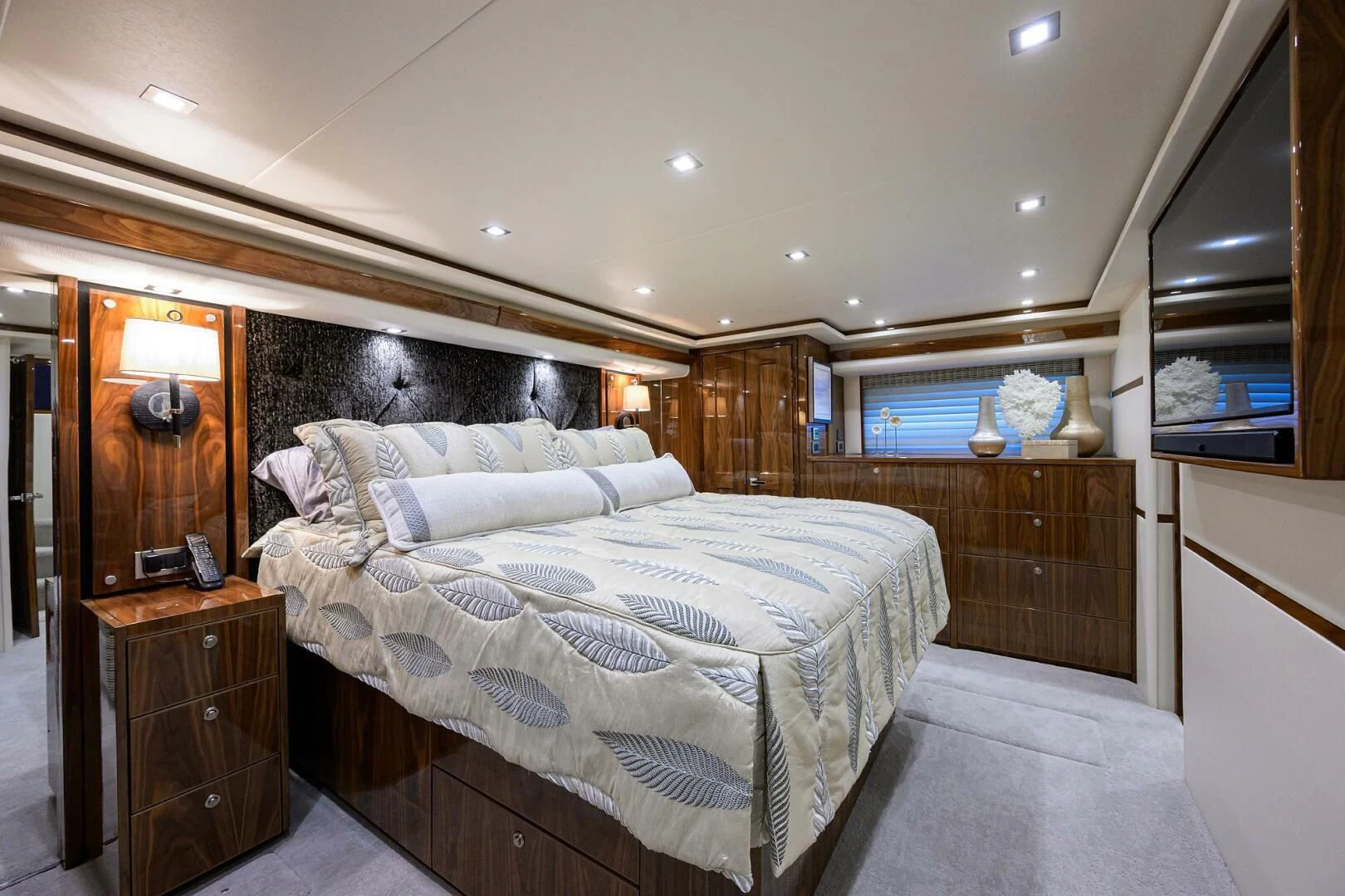 a bedroom with a bed and a dresser aboard FORTY NINER Yacht for Sale
