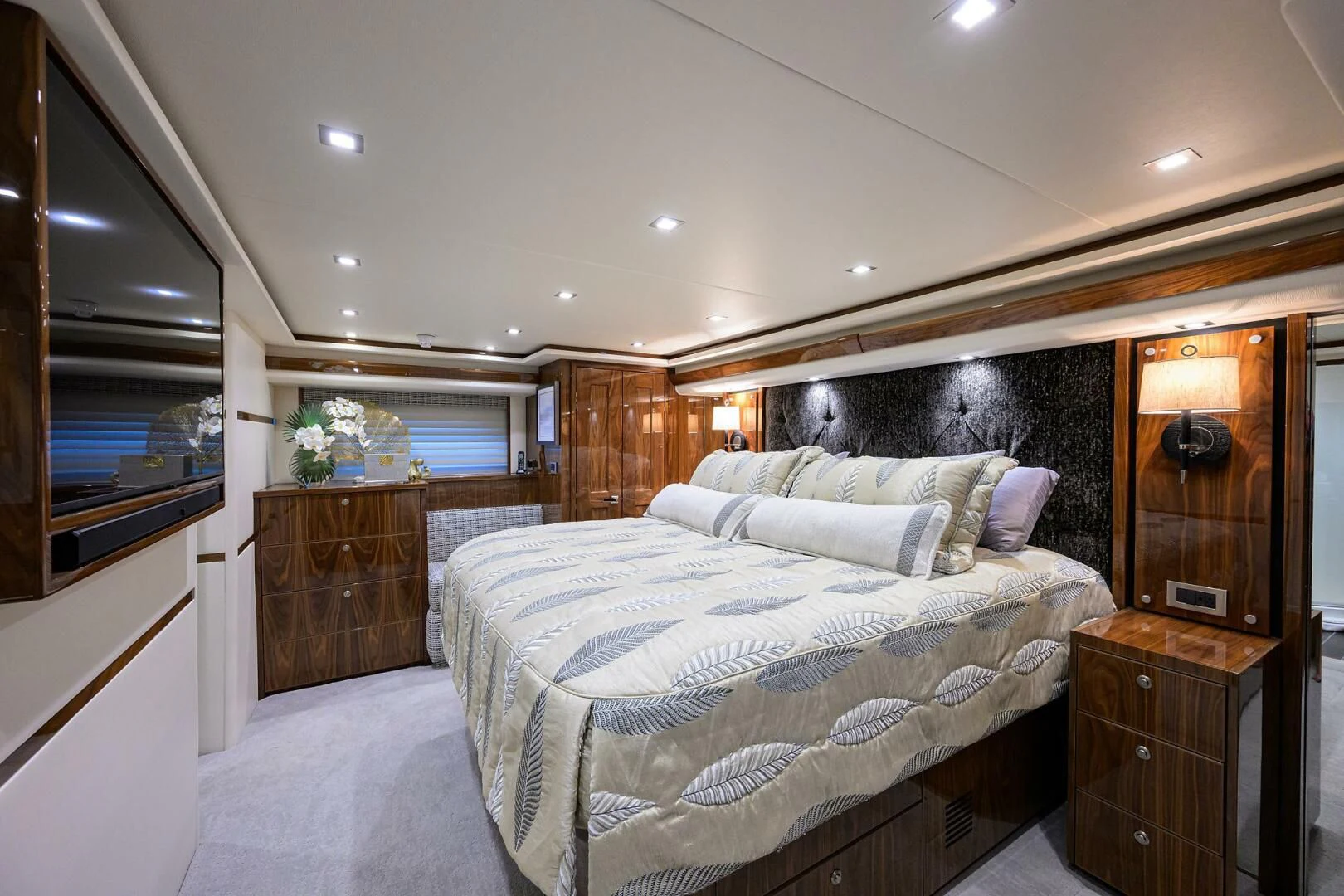 a bedroom with a bed and a dresser aboard FORTY NINER Yacht for Sale