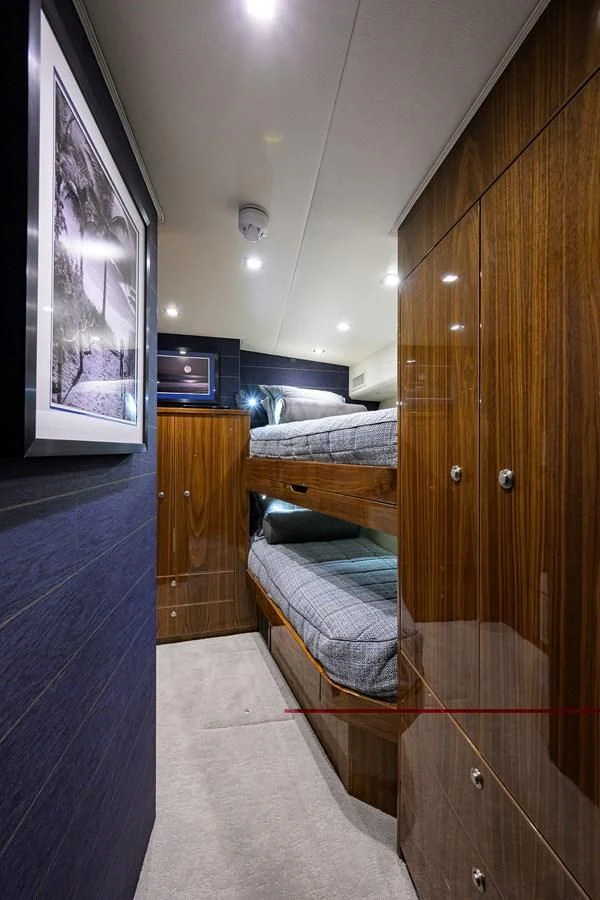 a room with a bed and a wood cabinet aboard FORTY NINER Yacht for Sale