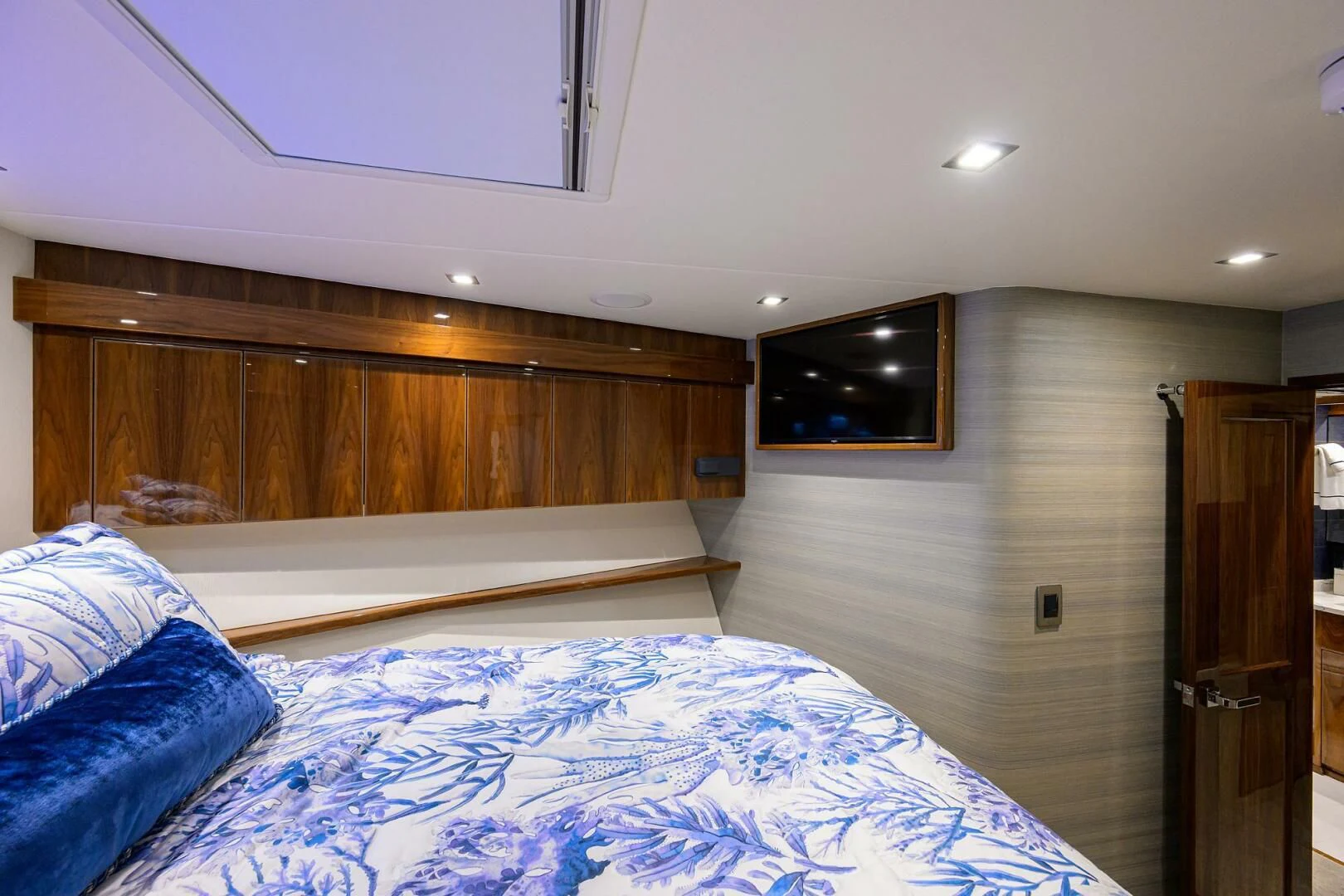 a bedroom with a bed and a television on the wall aboard FORTY NINER Yacht for Sale