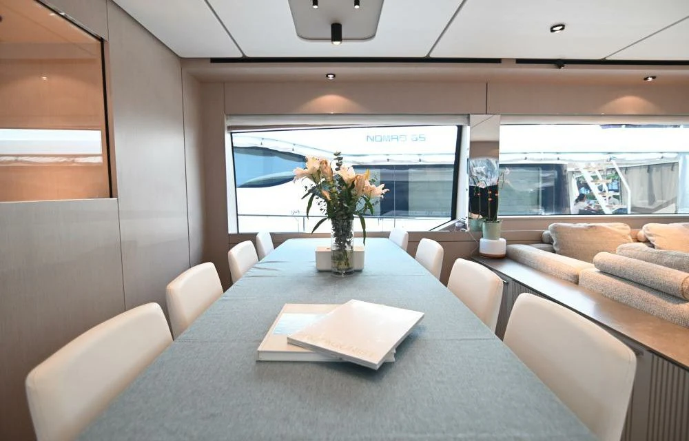 a room with a table and couches aboard JOYOUS JOURNEY Yacht for Sale