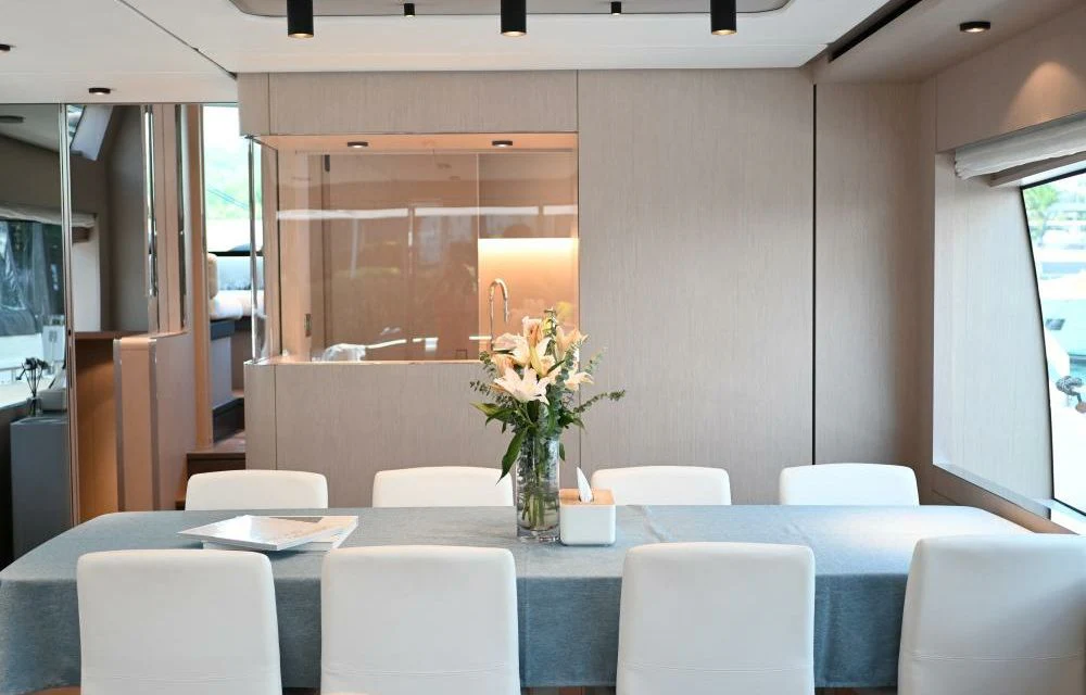 a table with white chairs and white chairs aboard JOYOUS JOURNEY Yacht for Sale