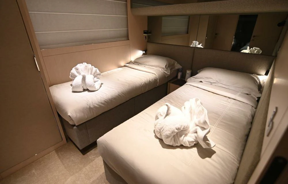 a room with two beds aboard JOYOUS JOURNEY Yacht for Sale