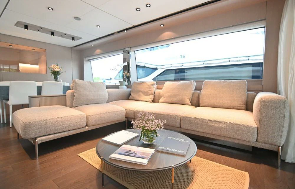 a living room with a couch and a table aboard JOYOUS JOURNEY Yacht for Sale