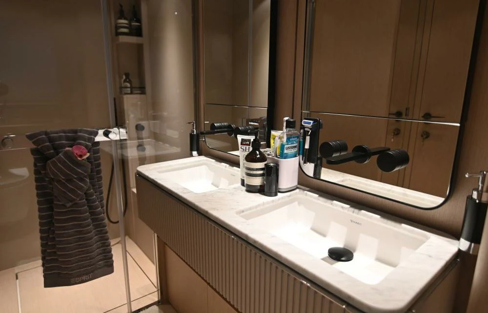 a bathroom with a sink and a mirror aboard JOYOUS JOURNEY Yacht for Sale