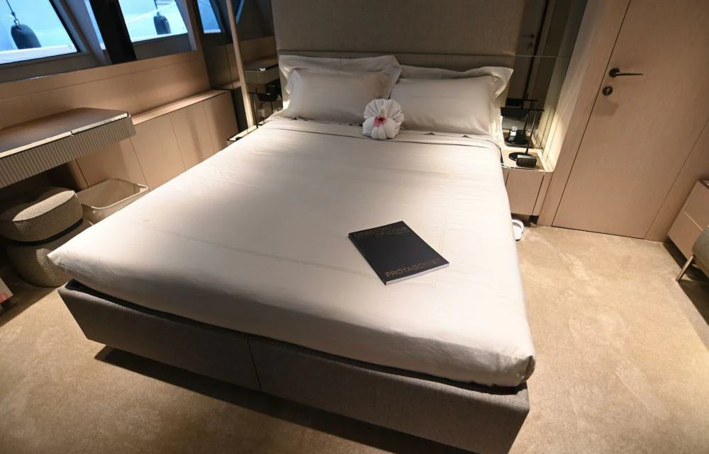 a bed with a laptop on it aboard JOYOUS JOURNEY Yacht for Sale