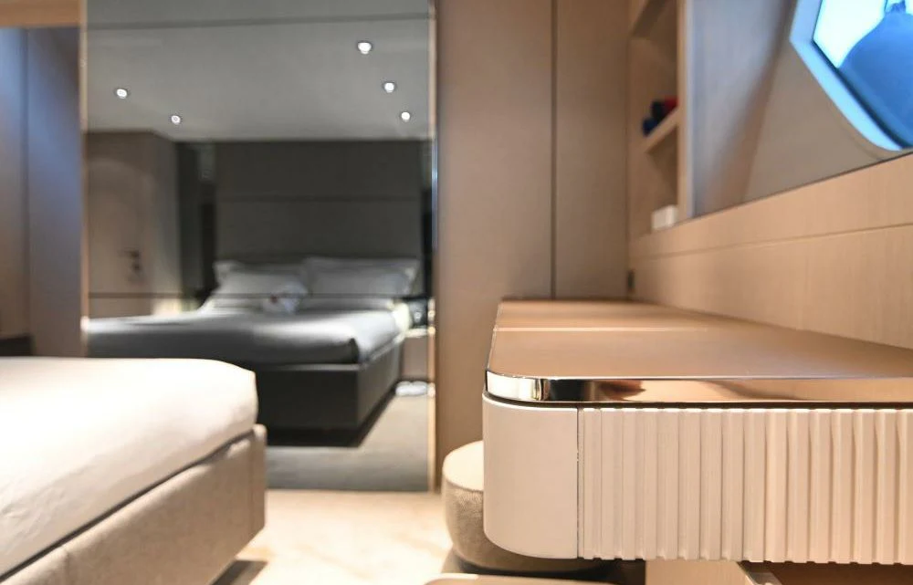 a room with a bed and a desk aboard JOYOUS JOURNEY Yacht for Sale