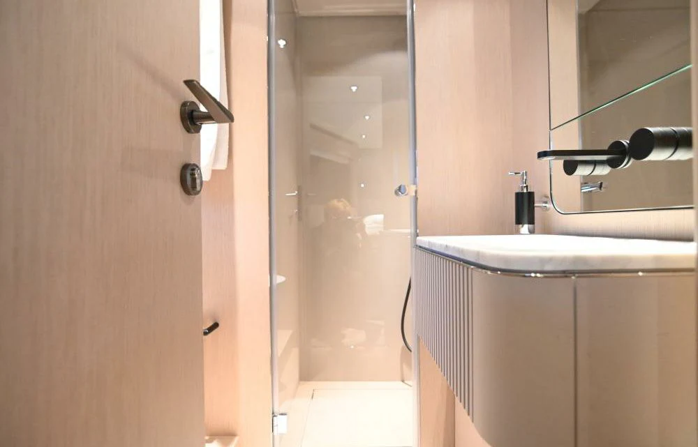 a bathroom with a sink and a shower aboard JOYOUS JOURNEY Yacht for Sale